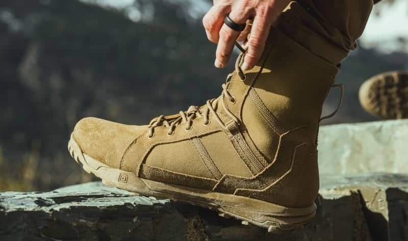 Close up of tying shoelace on tactical boots