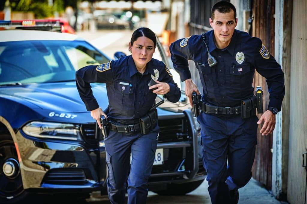 Female and male cop running on scene