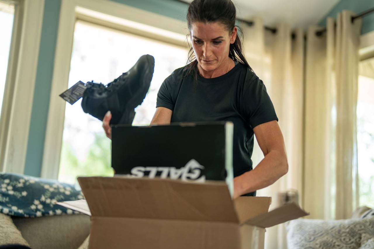 Female officer unboxing new duty boots