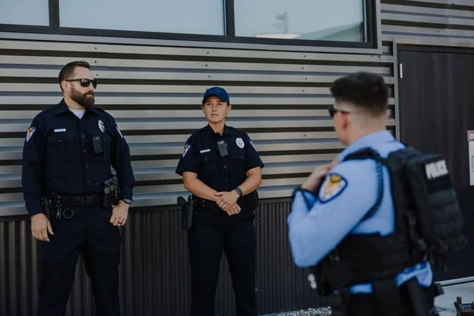 Police officers huddled together