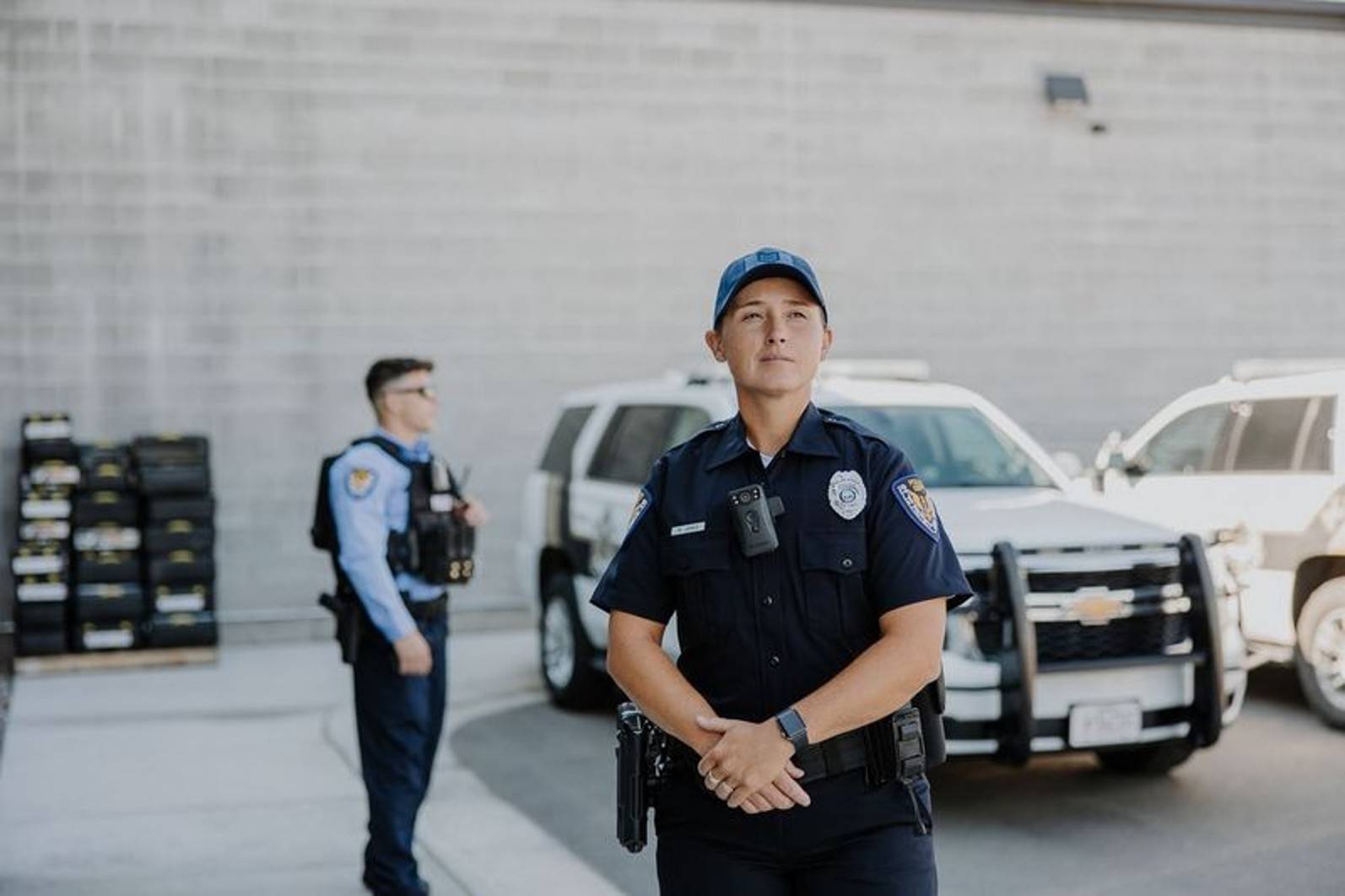 Police officers standing in front of police vehicles