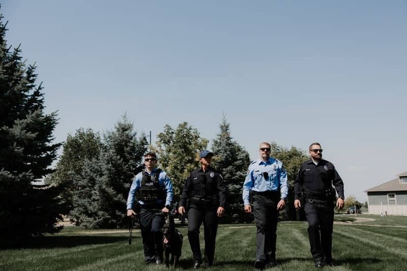 Police officers walking together across lawn
