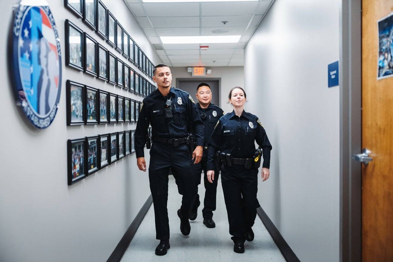 Police officers walking down a hall